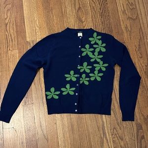 The. Cutest. Cardigan. Navy blue with green graphic floral motif across front.